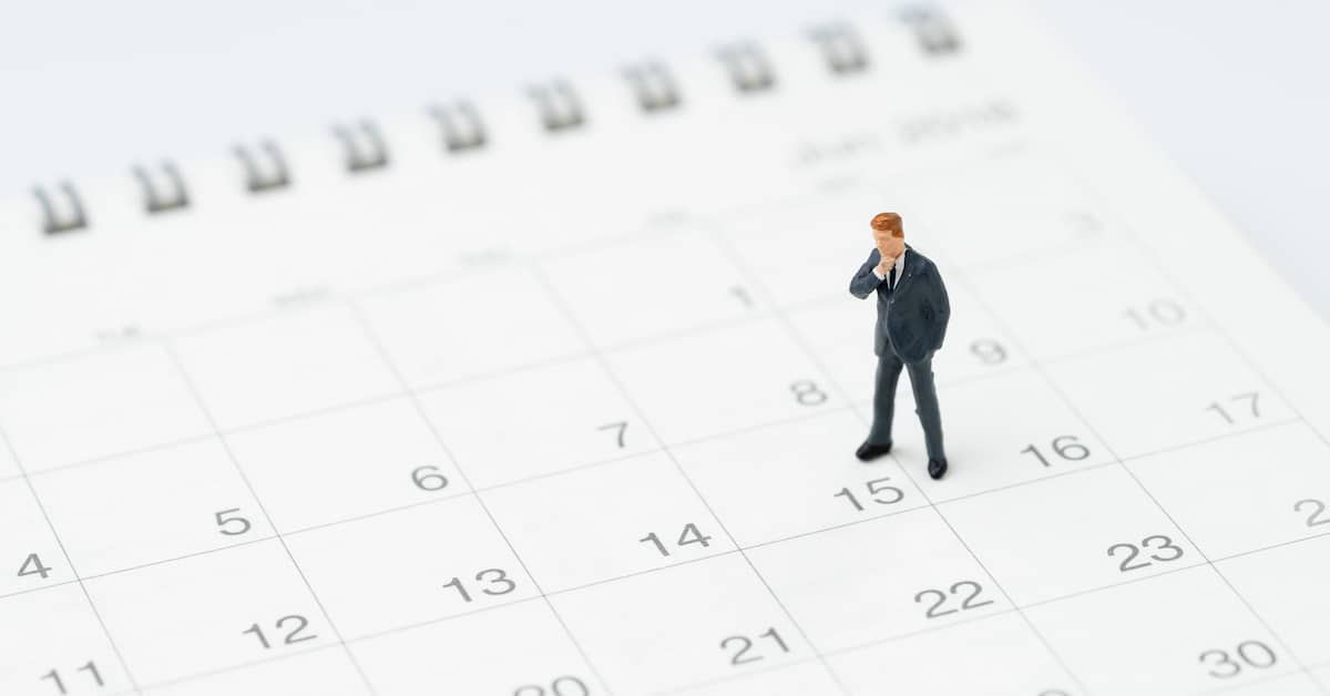 Figurine of a personal injury lawyer stands on top of a calendar. | Patrick Daniel Law