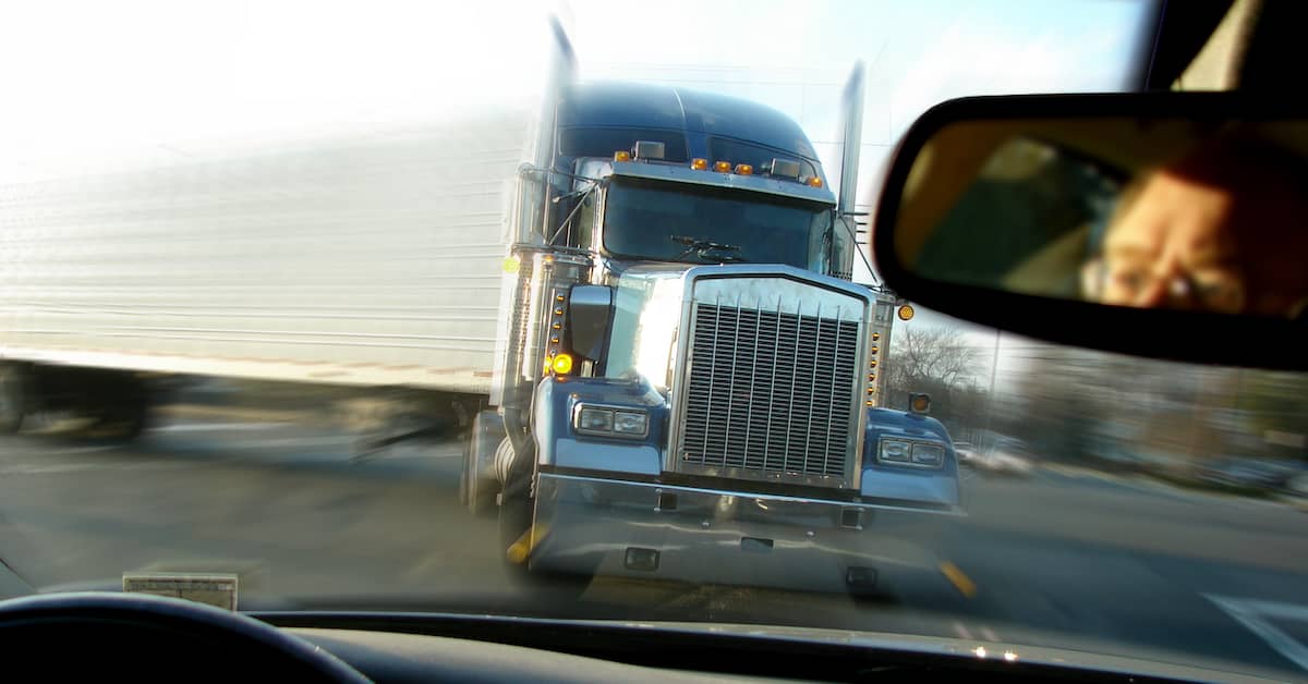 18-wheeler truck about to hit a car. | Patrick Daniel Law