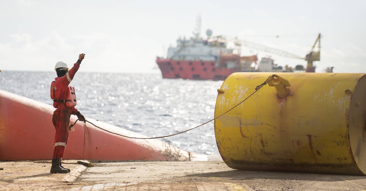 maritime worker handling rigging on the deck of a ship