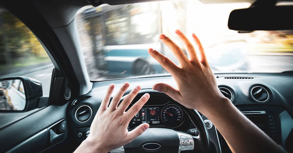 driver putting up his hands for protection before crashing into a bus