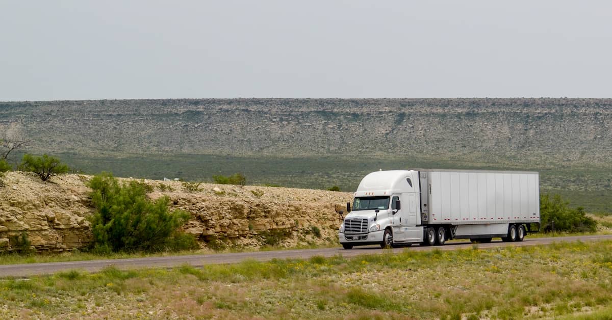 18-wheeler traveling on desert highway in Texas