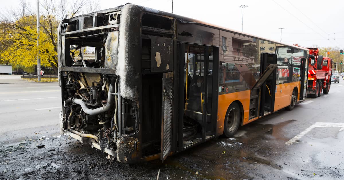 burned out frame of a city bus after a fiery accident