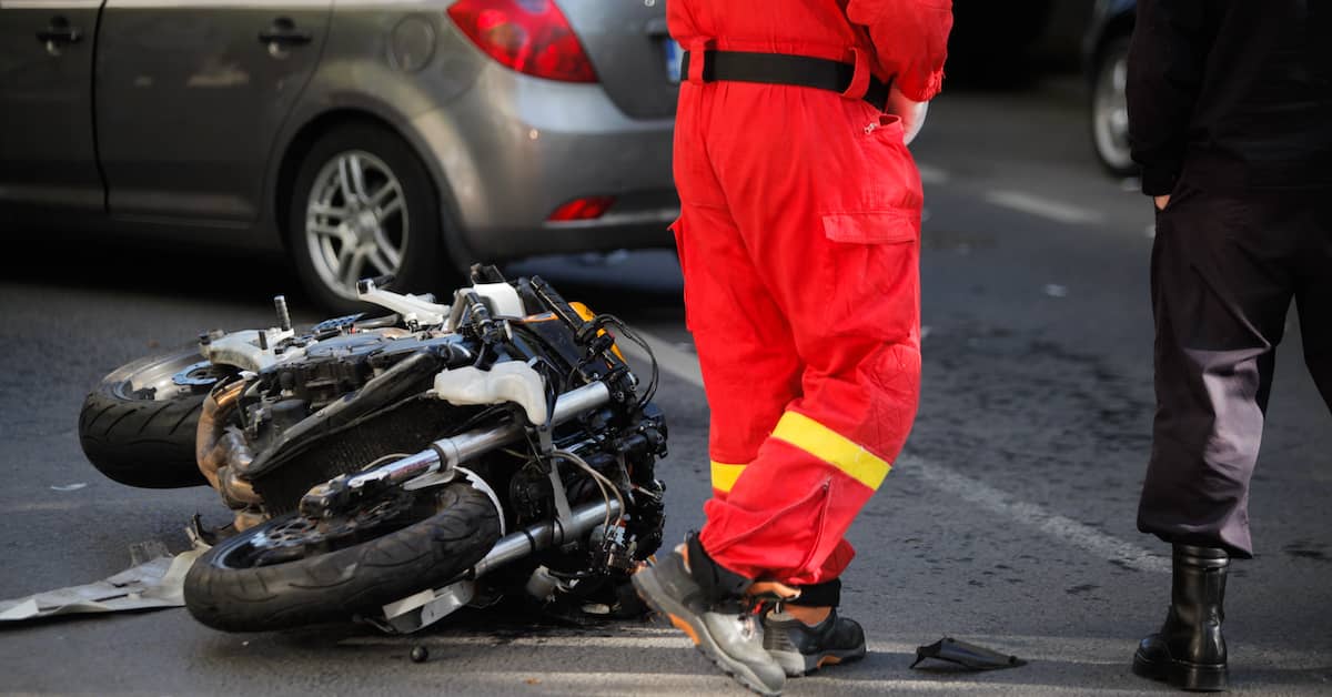 EMT stands next to a crashed motorcycle. | Patrick Daniel Law