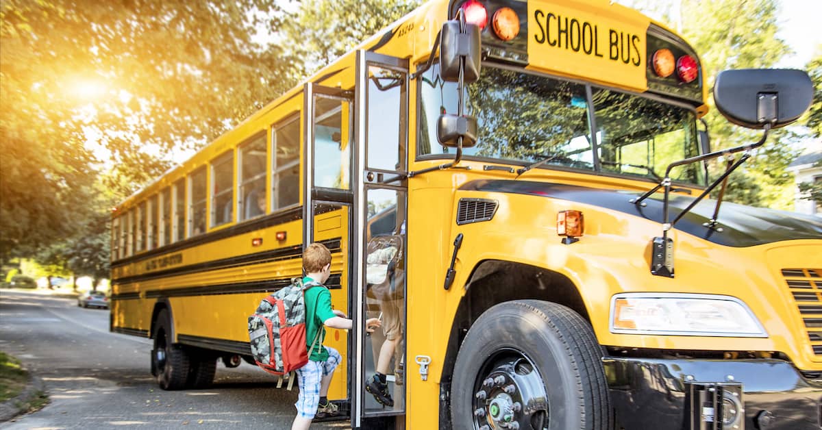 Children getting on the school bus. | Patrick Daniel Law