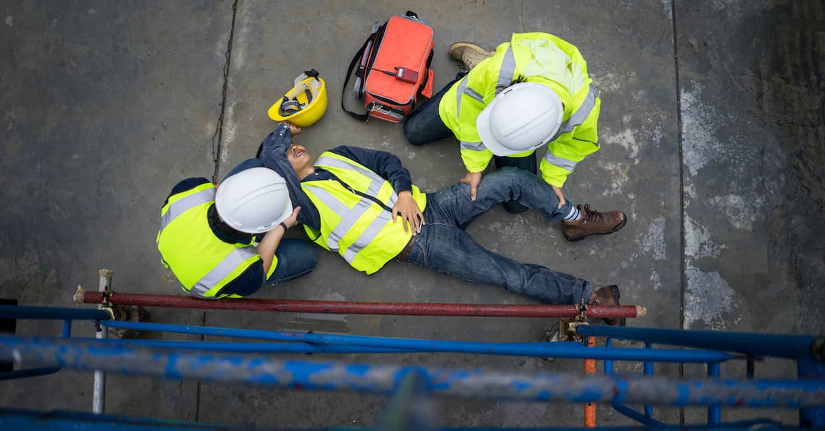Worker injured from fall with two people helping. | Patrick Daniel Law